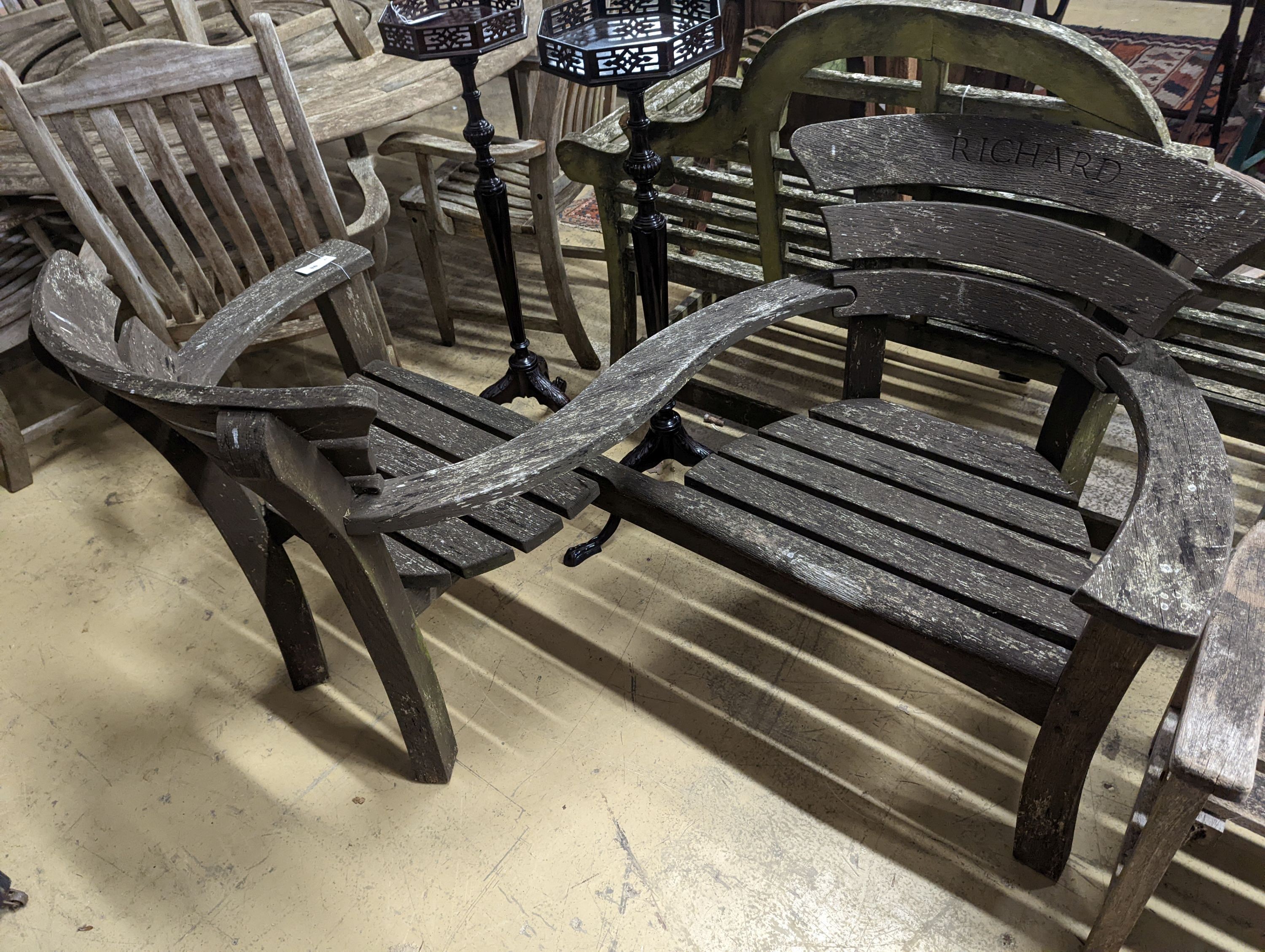 A weathered teak garden 'love seat', length 156cm, depth 100cm, height 93cm